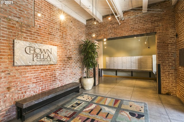 Welcoming lobby with exposed brick walls and Chown Pella signage
